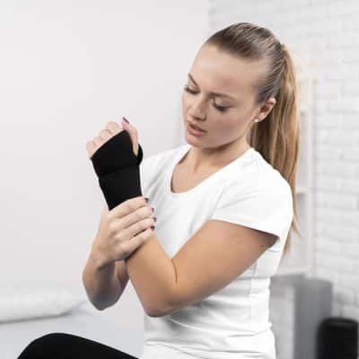 woman-with-wrapped-wrist-physiotherapy