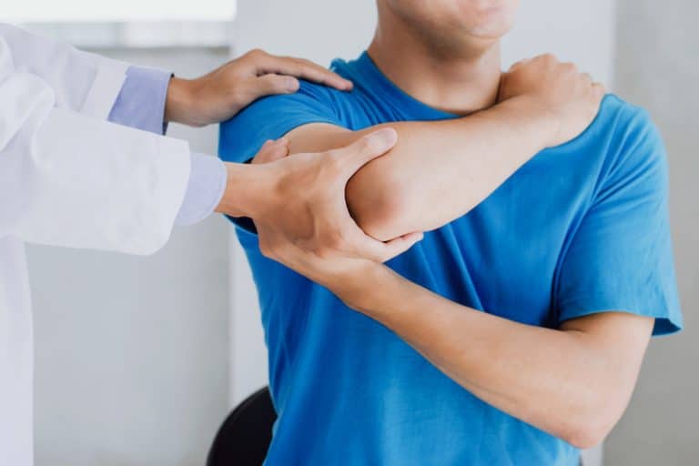 Professional physiotherapists provide assistance to male patients with arm injuries examine patients in clinic. Doing the Rehabilitation therapy pain in clinic.Rehabilitation physiotherapy concept